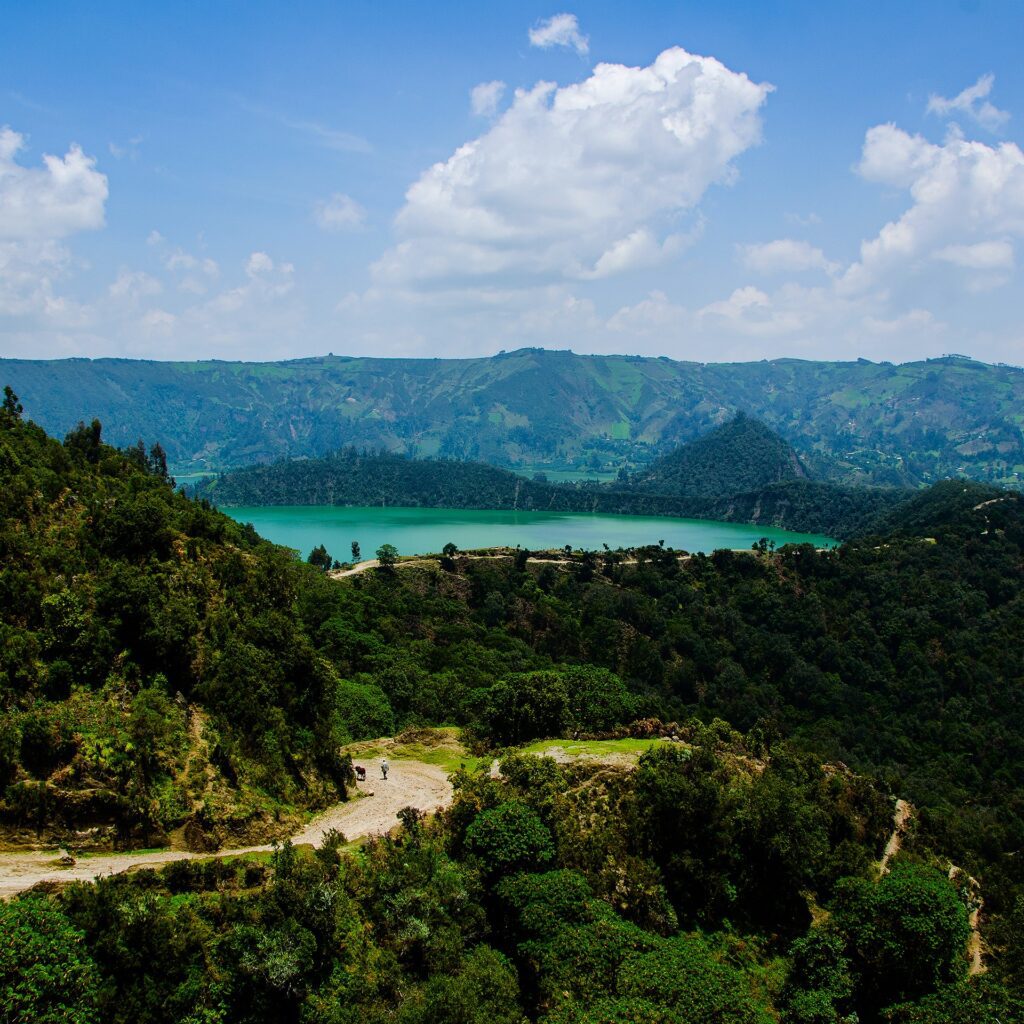 alt="Scenic view of Wonchi Crater Lake surrounded by Ethiopian highlands on a day trip from Addis Ababa"